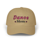 A khaki baseball cap featuring the embroidered text Dance Mom on the front. 