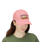 Woman wearing a pink embroidered classic dad cap hat with a Lacrosse text and graphic