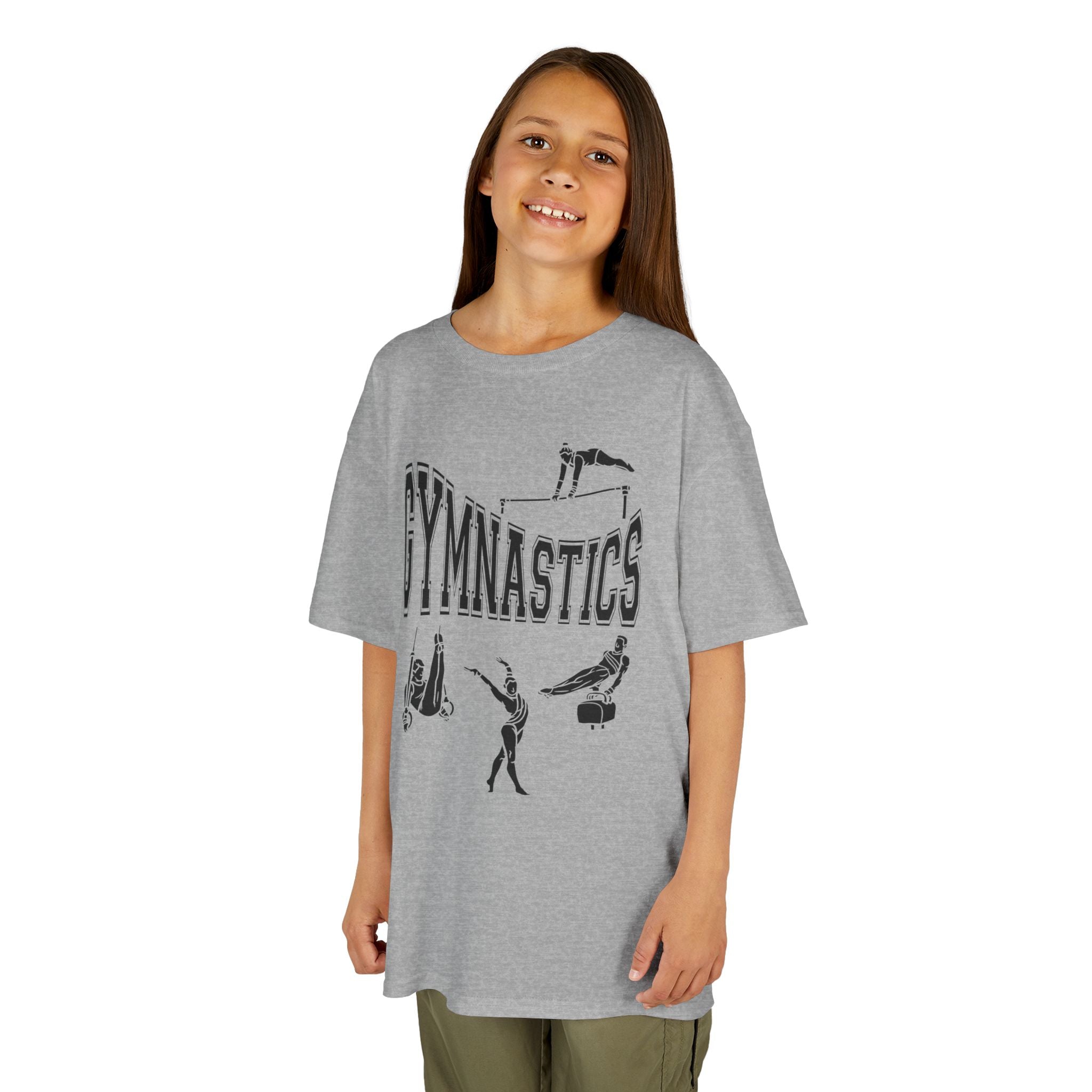 Young girl wearing a youth Gildan 5000B heavy cotton t-shirt in sport grey with a gymnastics text and graphic
