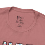 Close-up of a t-shirt's inner neck label with the brand Dance Vibe Designs printed above the care instructions.