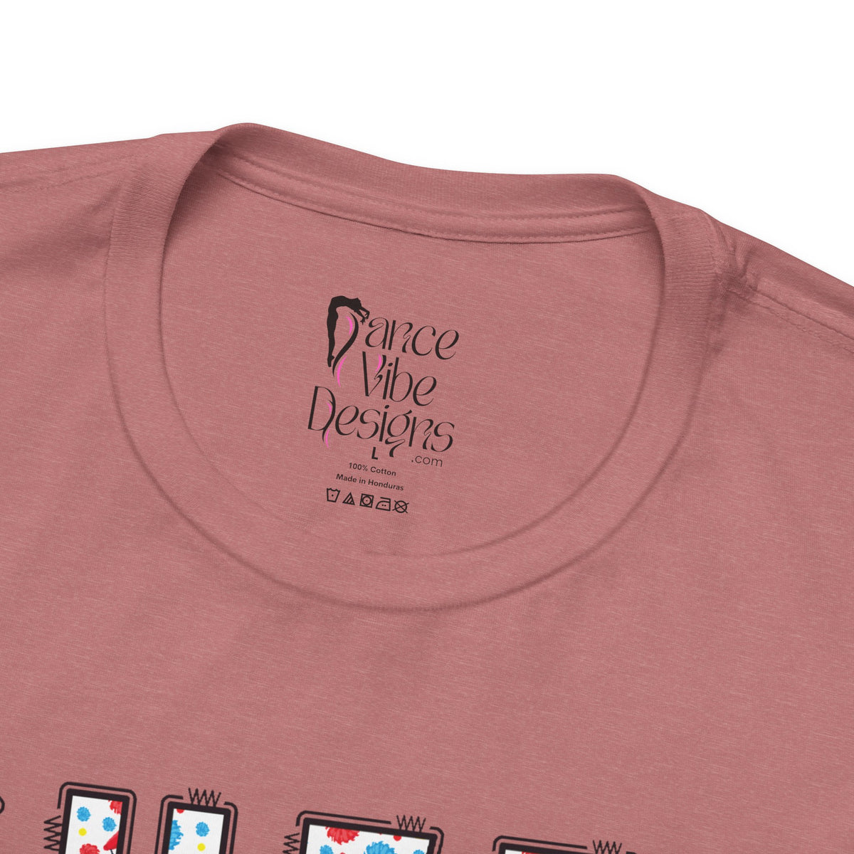 Close-up of a t-shirt's inner neck label with the brand Dance Vibe Designs printed above the care instructions.