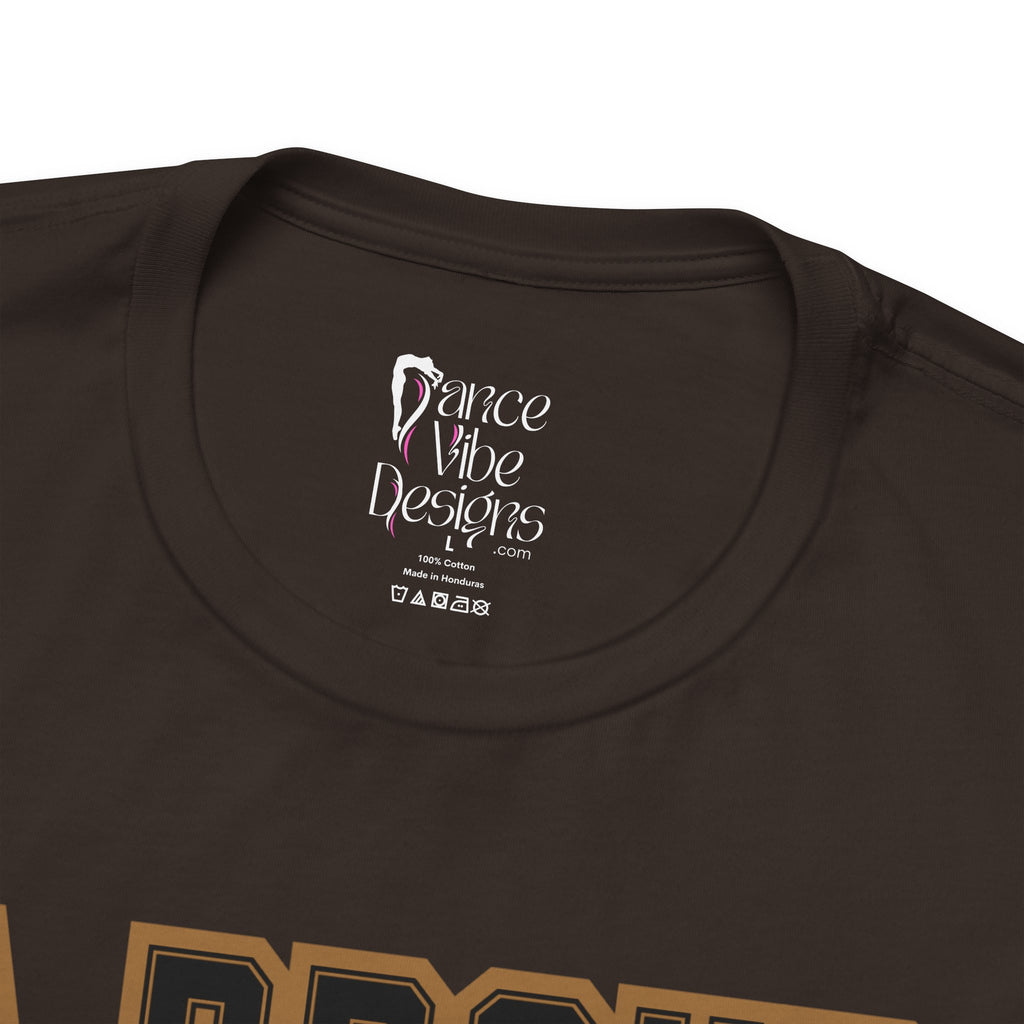 Close-up of a brown crewneck t-shirt's inner neck label printed with the brand Dance Vibe Designs logo above the care instructions.