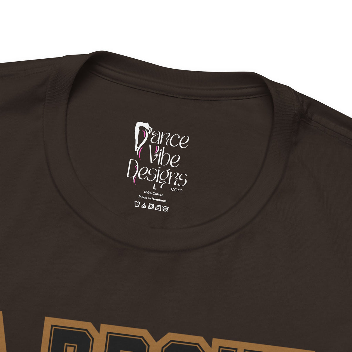 Close-up of a brown crewneck t-shirt's inner neck label printed with the brand Dance Vibe Designs logo above the care instructions.