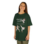 Young girl wearing a youth Gildan 5000B heavy cotton t-shirt in forest green with a Martial Arts text and graphic