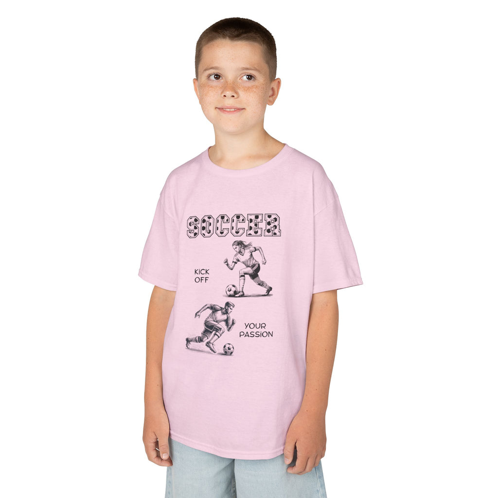 Young boy wearing a youth Gildan 5000B heavy cotton t-shirt in light pink with a Soccer text and graphic