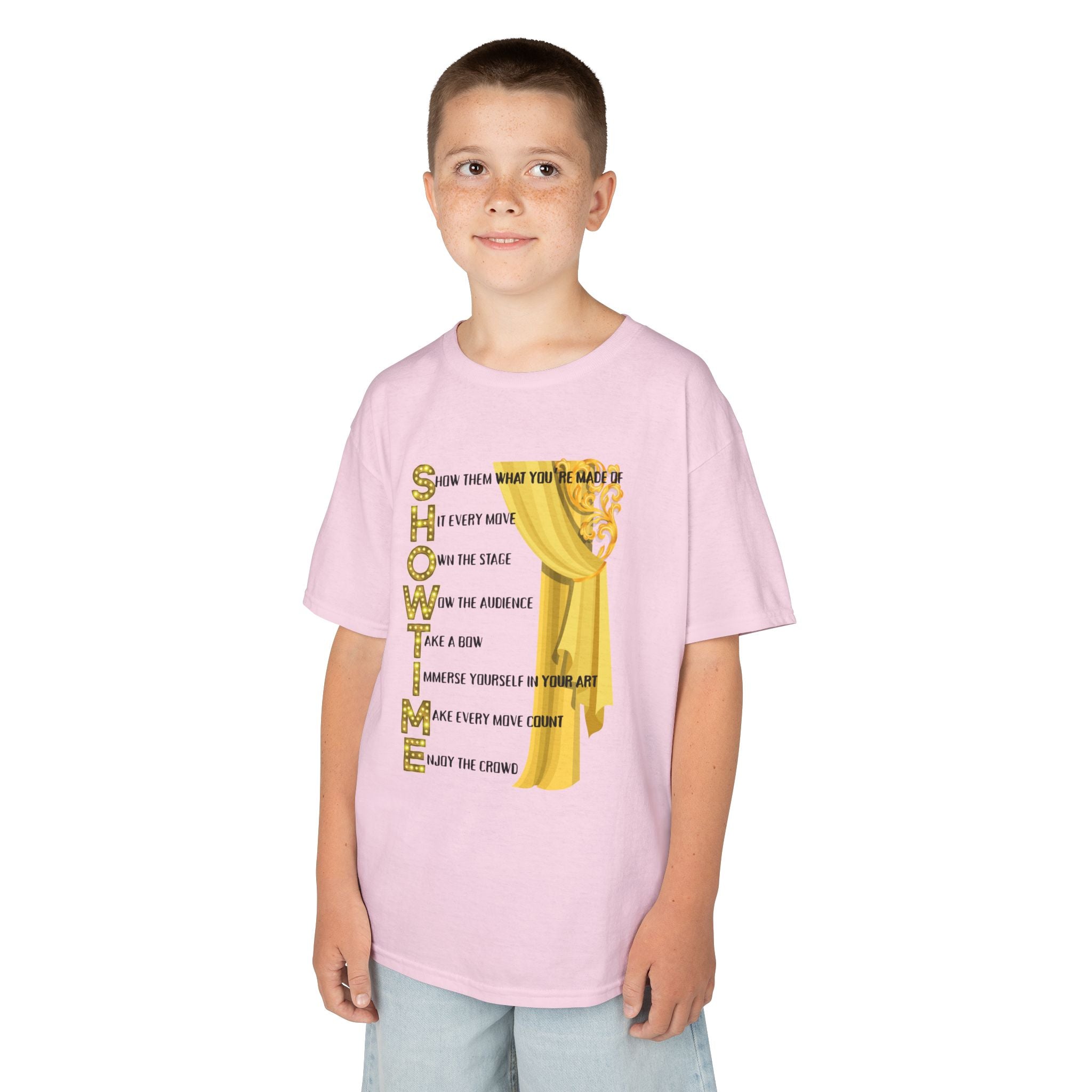 Young boy wearing a youth Gildan 5000B heavy cotton t-shirt in light pink with a Showtime text and graphic 