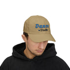 A man wearing a khaki baseball cap with Dance Dad embroidered on the front.
