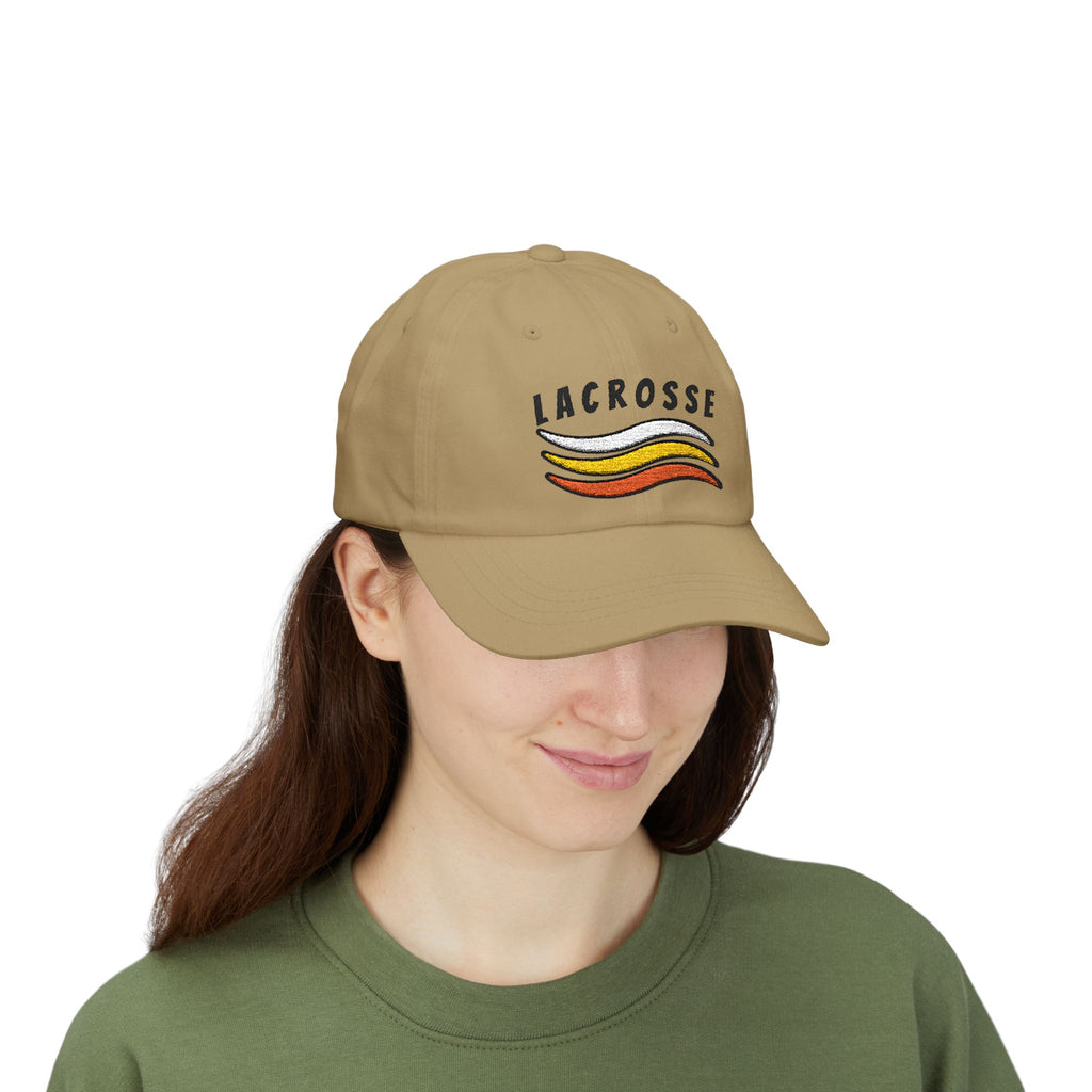 Woman wearing a khaki embroidered classic dad cap hat with a Lacrosse text and graphic