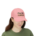Woman wearing a pink embroidered classic dad cap hat with a Play Tennis text and graphic