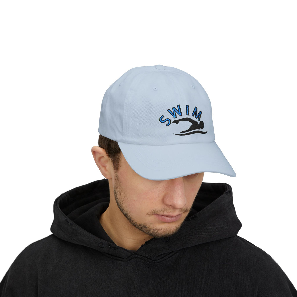 Man wearing a light blue embroidered classic dad cap hat with a Swim text and graphic