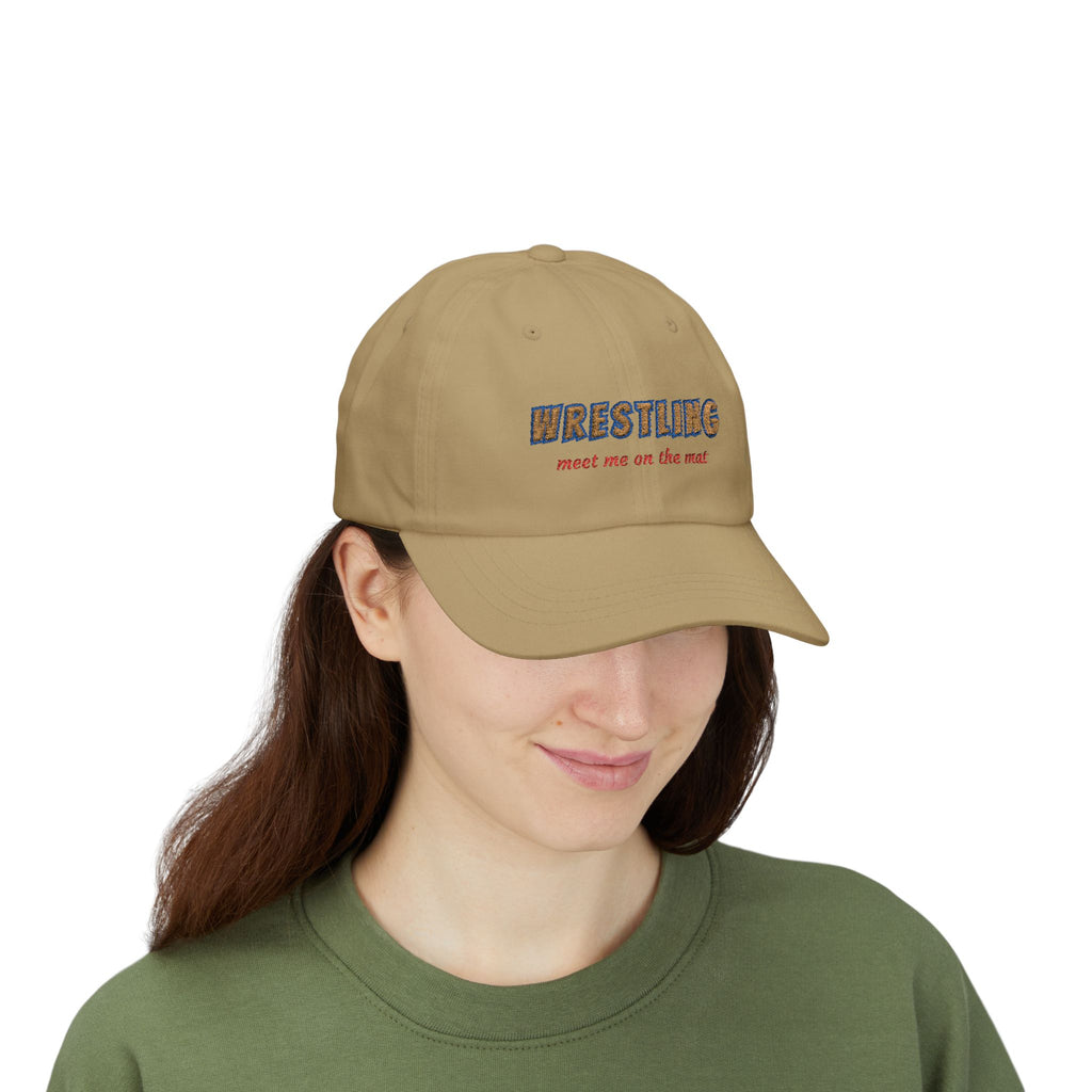 Woman wearing a khaki embroidered classic dad cap hat with a Wrestling Meet me on the Mat text 