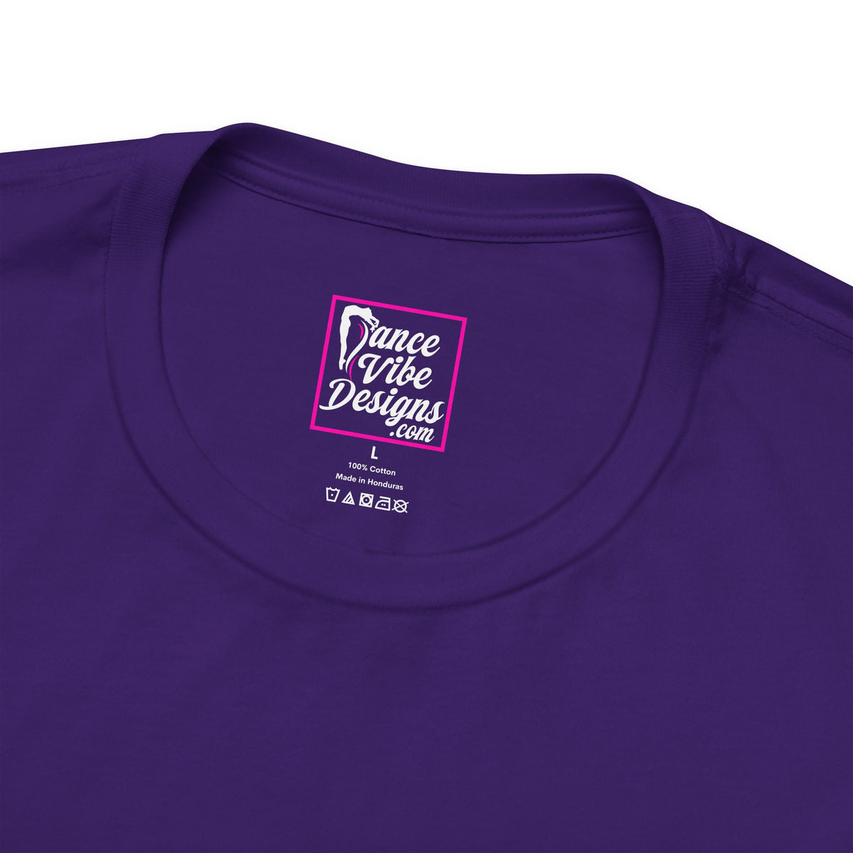 Close up view of a Dance Vibe Designs custom neck label above t-shirt care instructions.