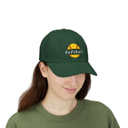 Woman wearing a spruce cap with an embroidered yellow softball graphic and text.