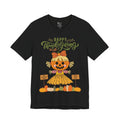 A black short-sleeve t-shirt with a Happy Thanksgiving graphic featuring a ballerina scarecrow design.