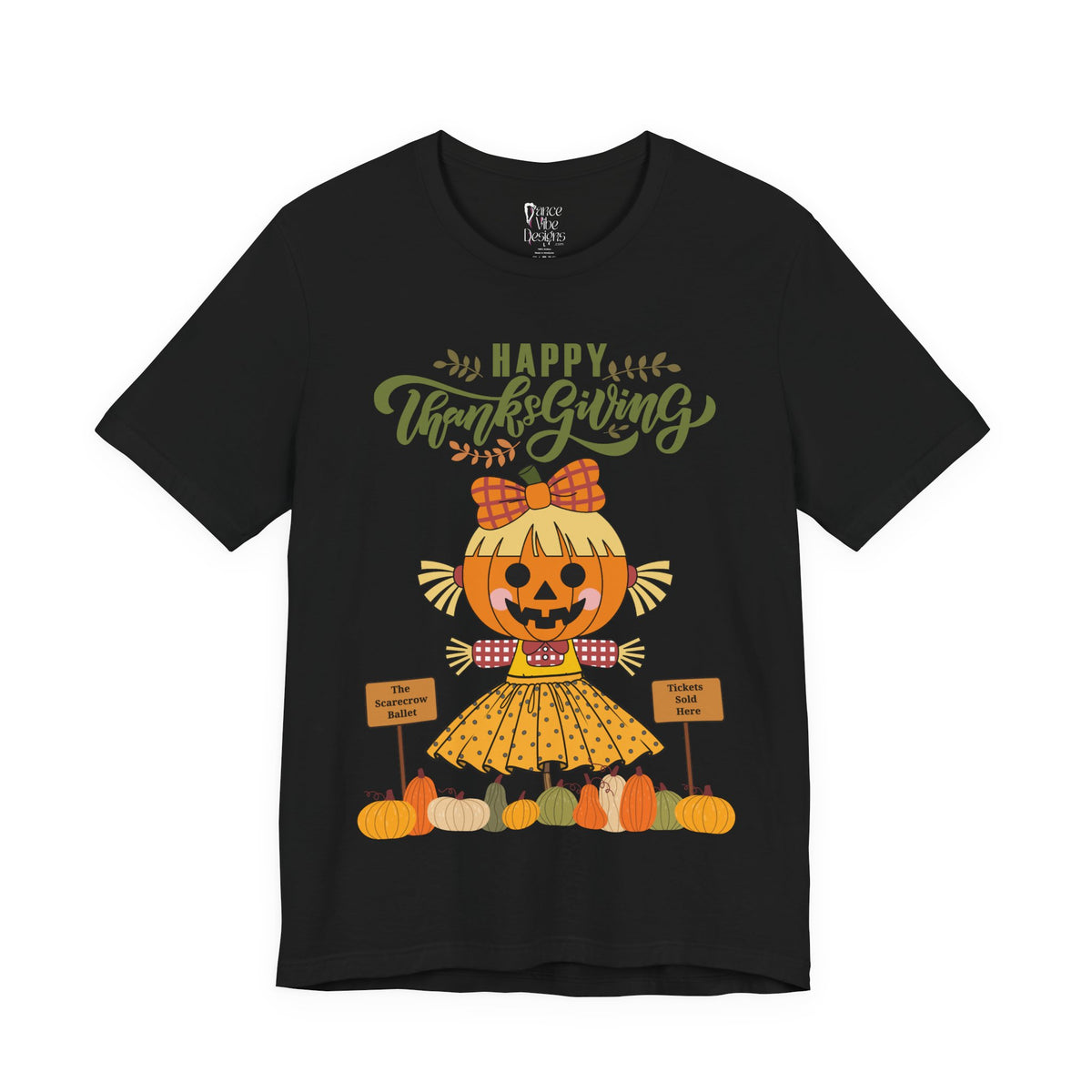 A black short-sleeve t-shirt with a Happy Thanksgiving graphic featuring a ballerina scarecrow design.