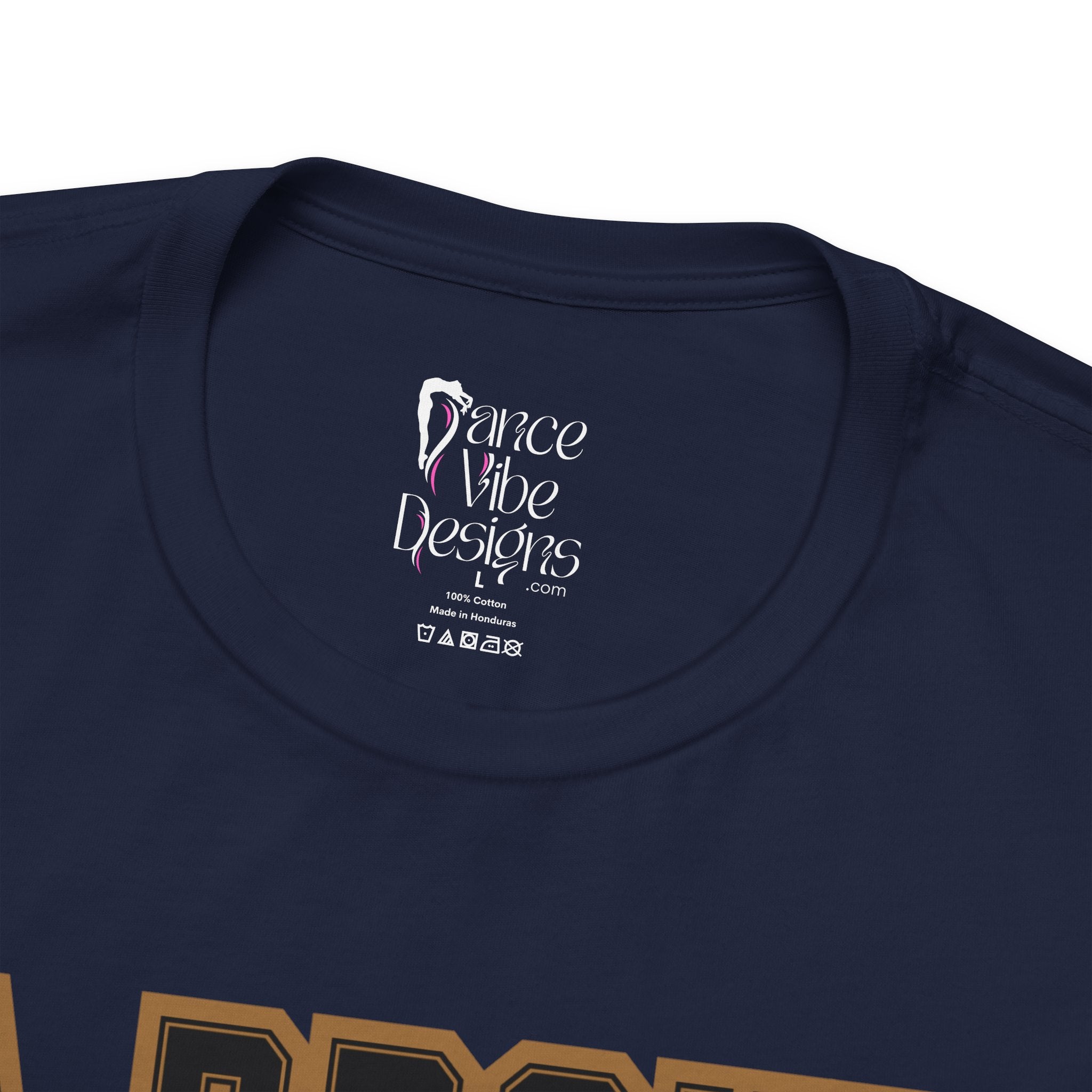 Close-up of a navy crewneck t-shirt's inner neck label printed with the brand Dance Vibe Designs logo above the care instructions.