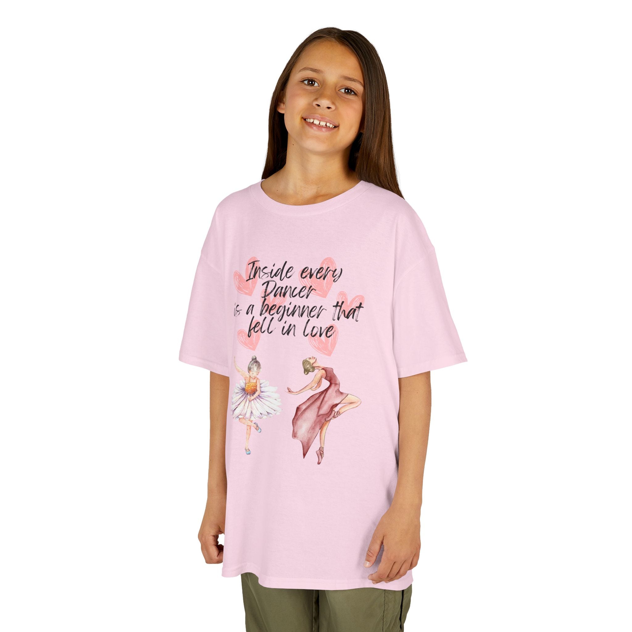 Young girl wearing a youth Gildan 5000B heavy cotton t-shirt in light pink with an Inside Every Dancer is a Beginner that Fell in Love theme