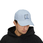 Man wearing a light blue embroidered classic dad cap hat with a Hockey text and graphic
