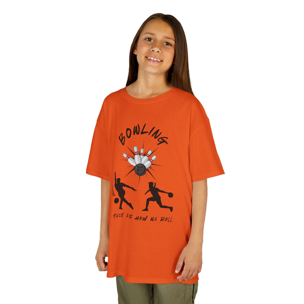 Young girl wearing a youth Gildan 5000B heavy cotton t-shirt in orange with a Bowling text and graphic