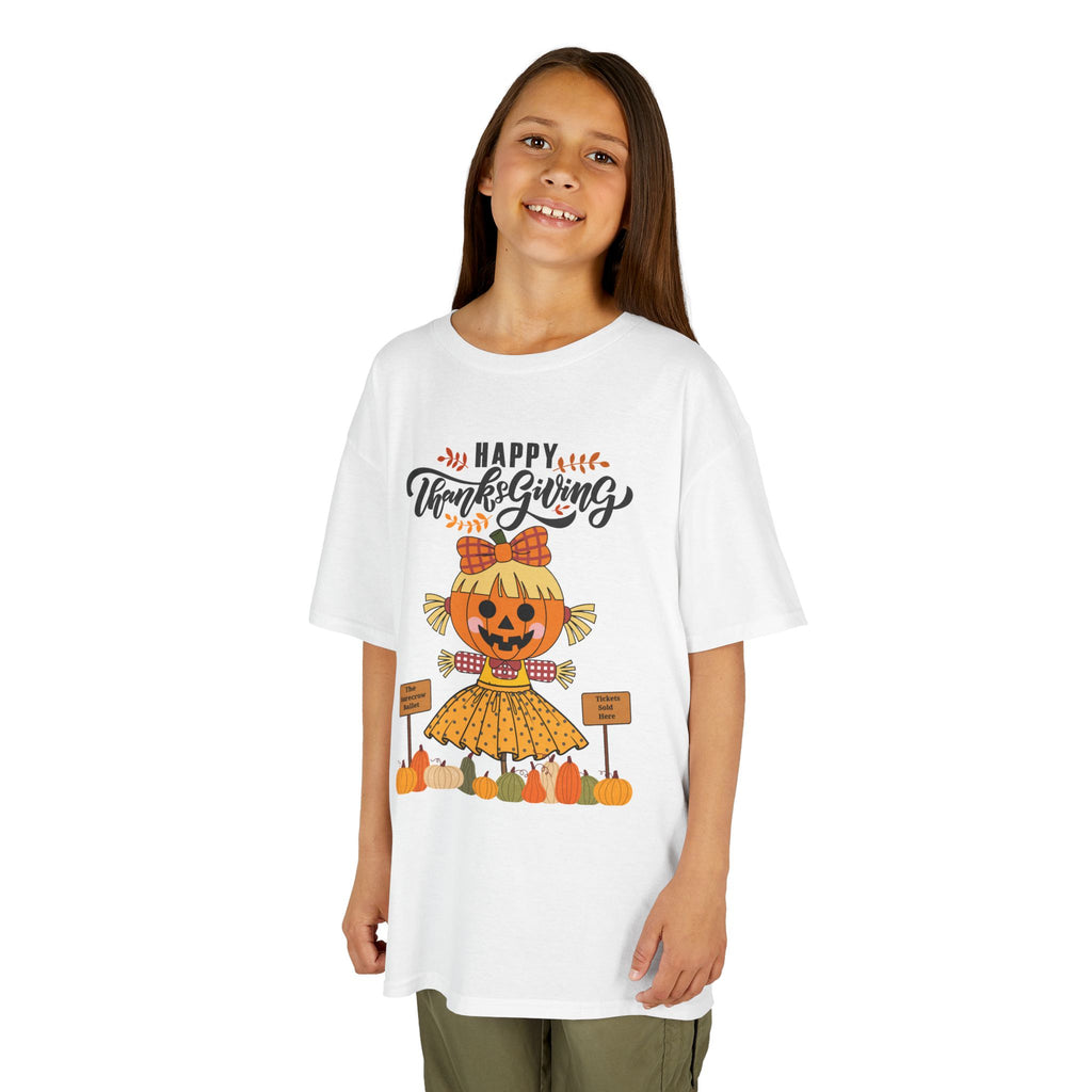 Young girl wearing a white Thanksgiving t-shirt with a scarecrow ballerina design and a Happy Thanksgiving text.