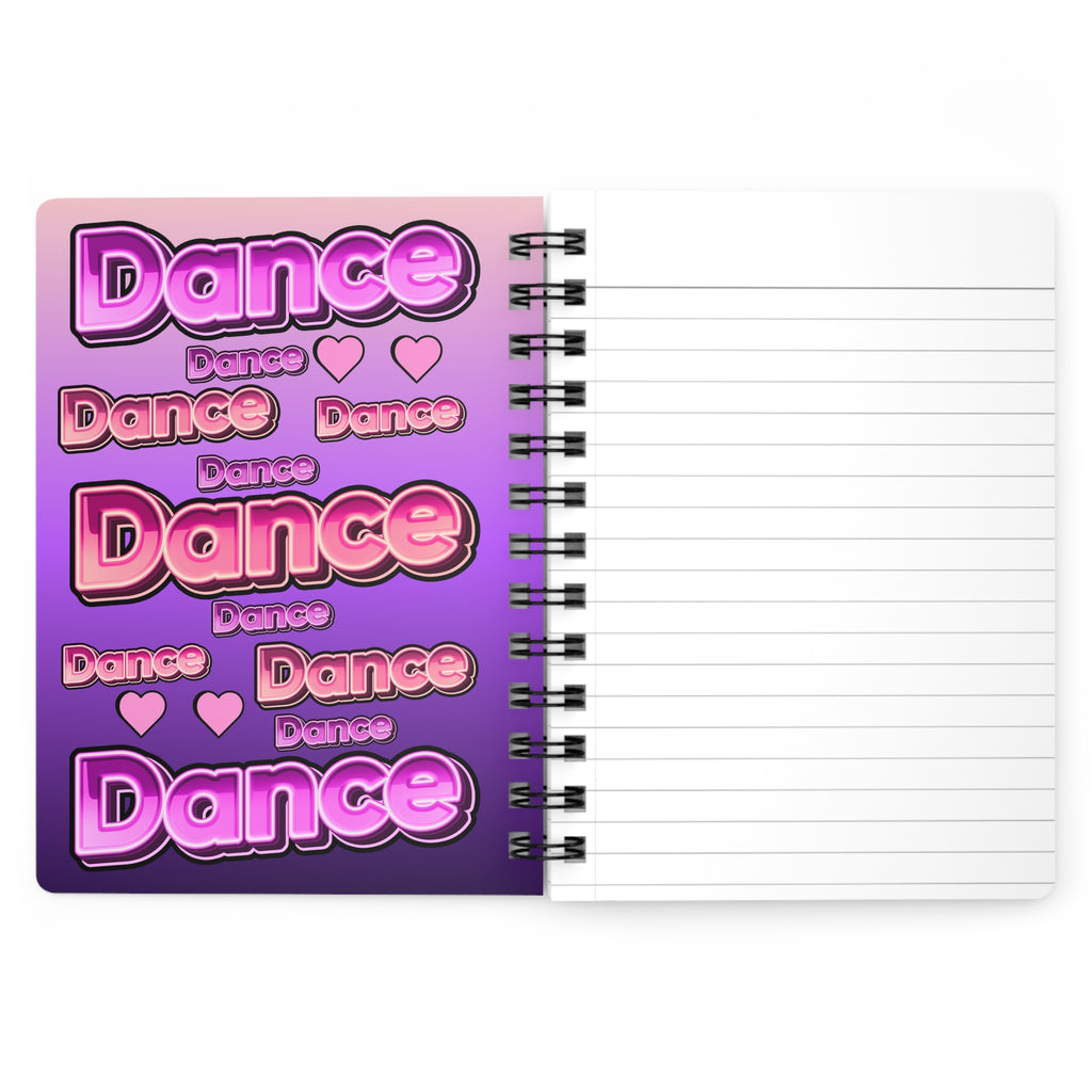 A spiral-bound lined notebook shown open. The left page has a colorful cover with the word 'Dance' repeated in pink and purple gradient lettering with small heart icons.