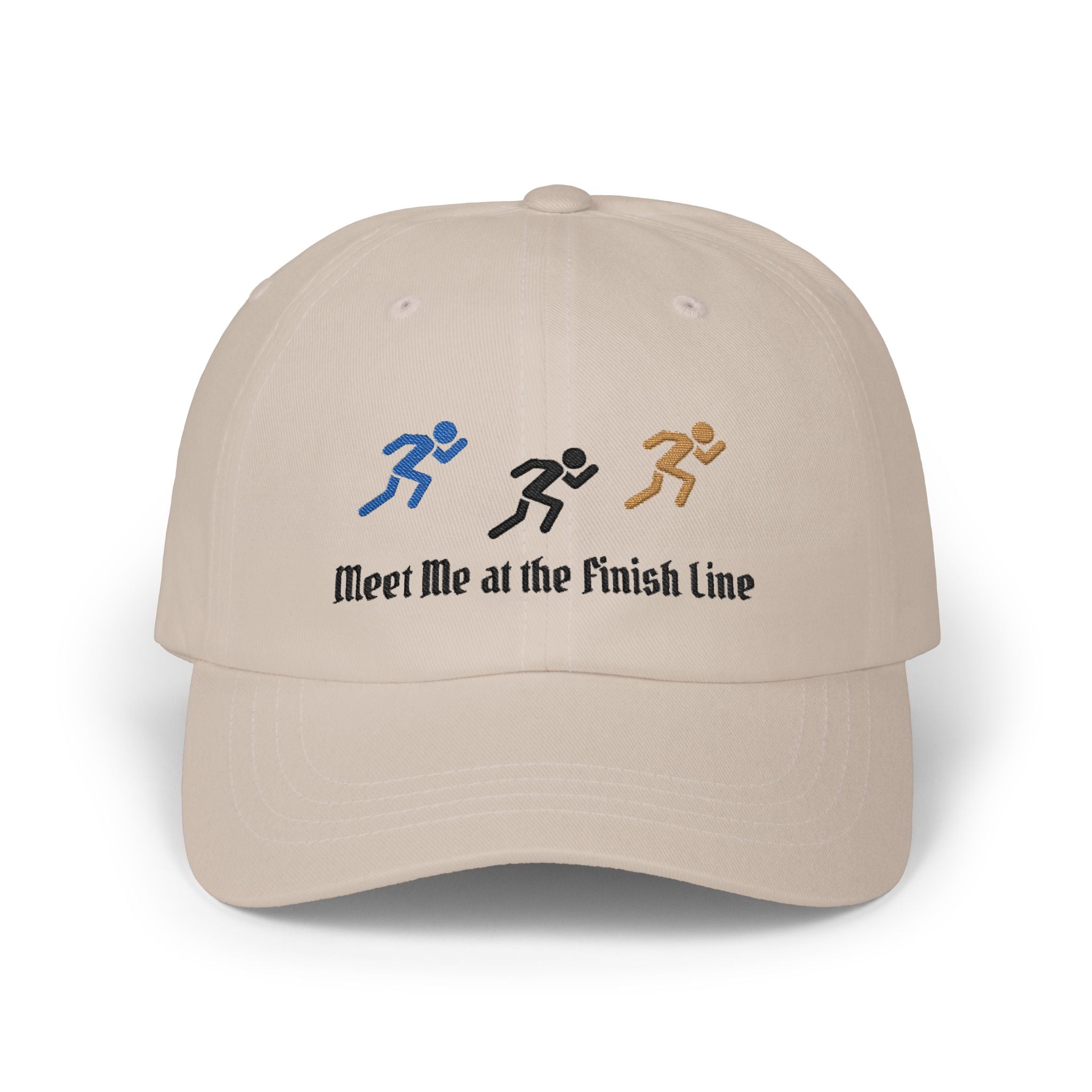 A stone baseball cap featuring embroidered running figures in blue, black, and tan above the text Meet Me at the Finish Line.