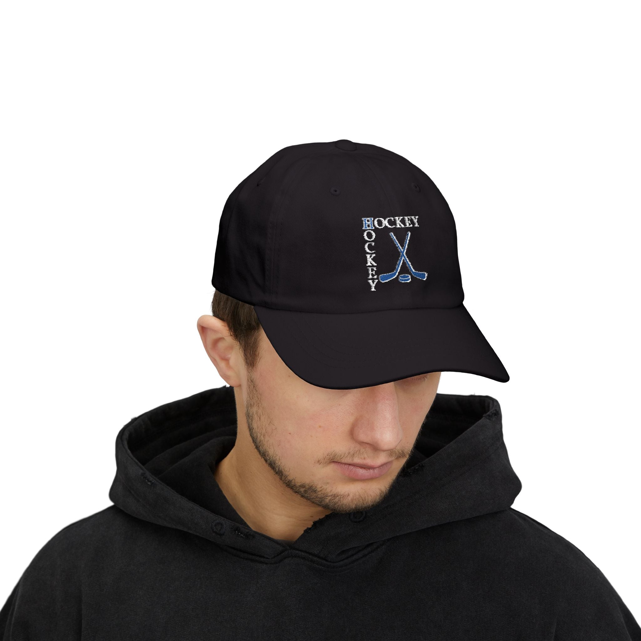 Man wearing a black cap with an embroidered Hockey text and logo.
