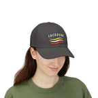 Man wearing a dark grey cap with a Lacrosse text and colorful design embroidered on the front. 