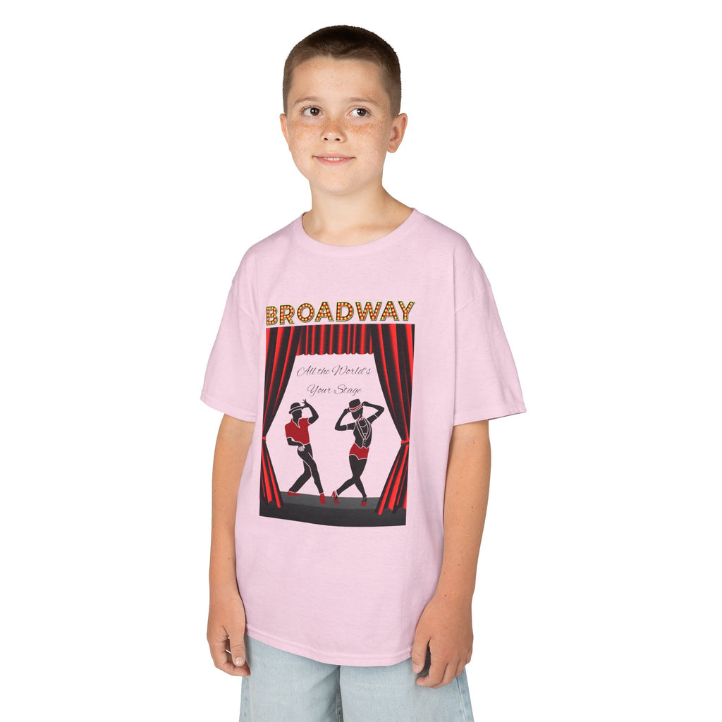 Young boy wearing a youth Gildan 5000B heavy cotton t-shirt in light pink with a Broadway text and graphic