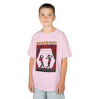Young boy wearing a youth Gildan 5000B heavy cotton t-shirt in light pink with a Broadway text and graphic