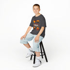Young boy wearing a charcoal short-sleeve t-shirt with a colorful graphic of cartoon turkeys and the phrase GOBBLE TIL YOU WOBBLE on the front.