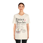A young woman wearing a natural short-sleeve crewneck t-shirt featuring a text that reads Dance Teacher and a ballet class graphic.
