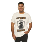 Man wearing a natural graphic T-shirt with a black chess knight design and the words A PROUD KNIGHT on the front.