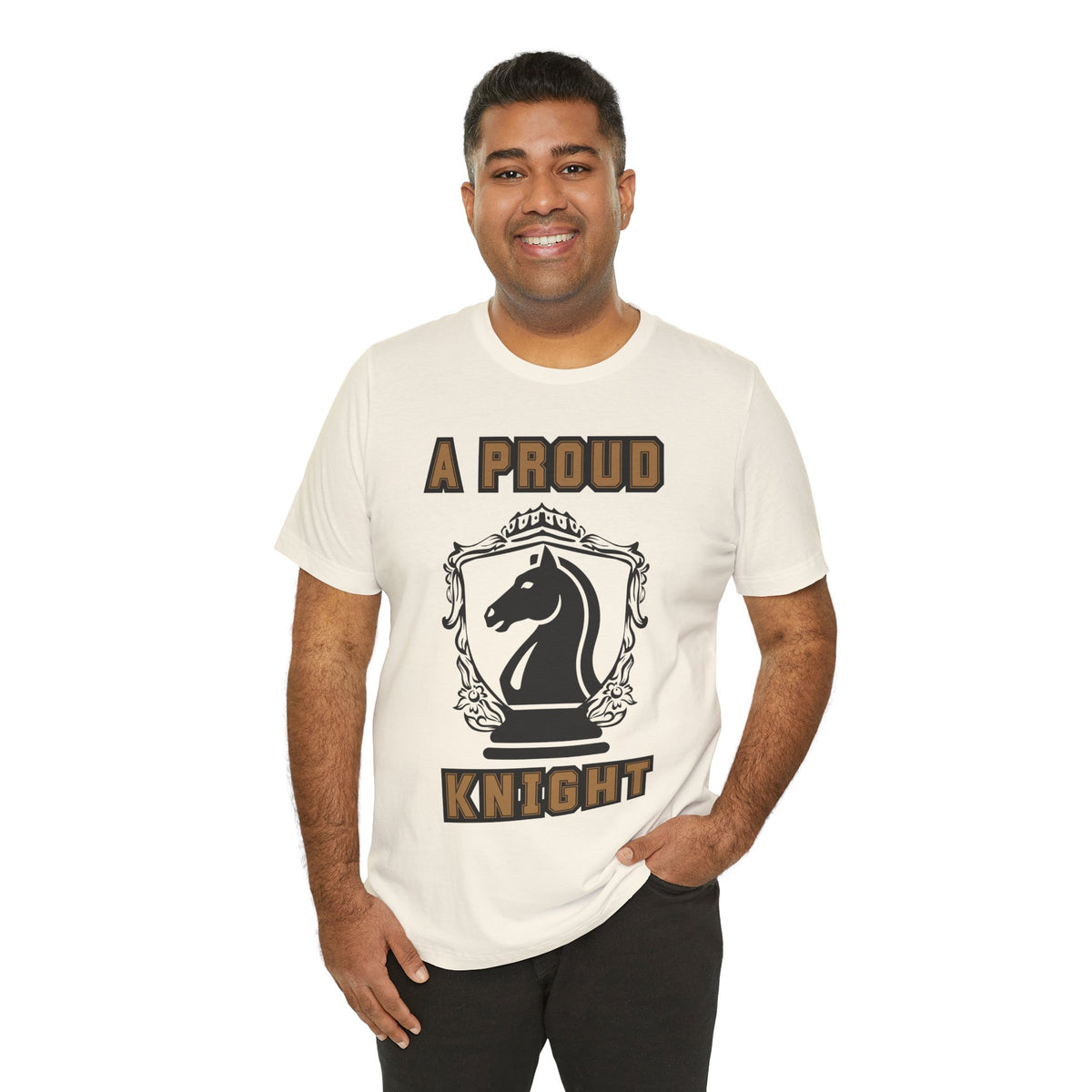 Man wearing a natural graphic T-shirt with a black chess knight design and the words A PROUD KNIGHT on the front.