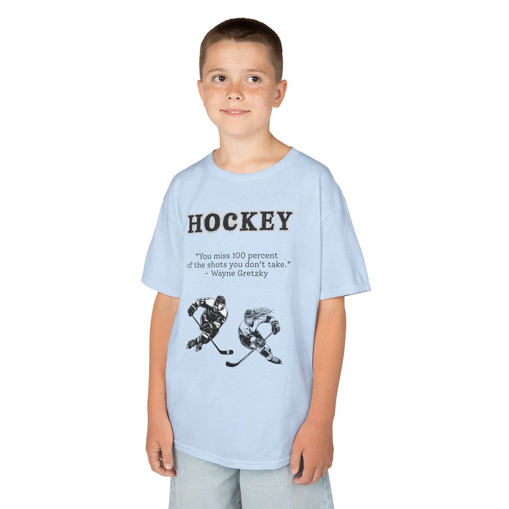 Young boy wearing a youth Gildan 5000B heavy cotton t-shirt in light blue with a Hockey text and graphic
