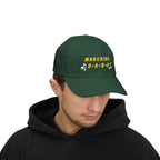 Man wearing a spruce cap with MARCHING BAND text and musical notes.