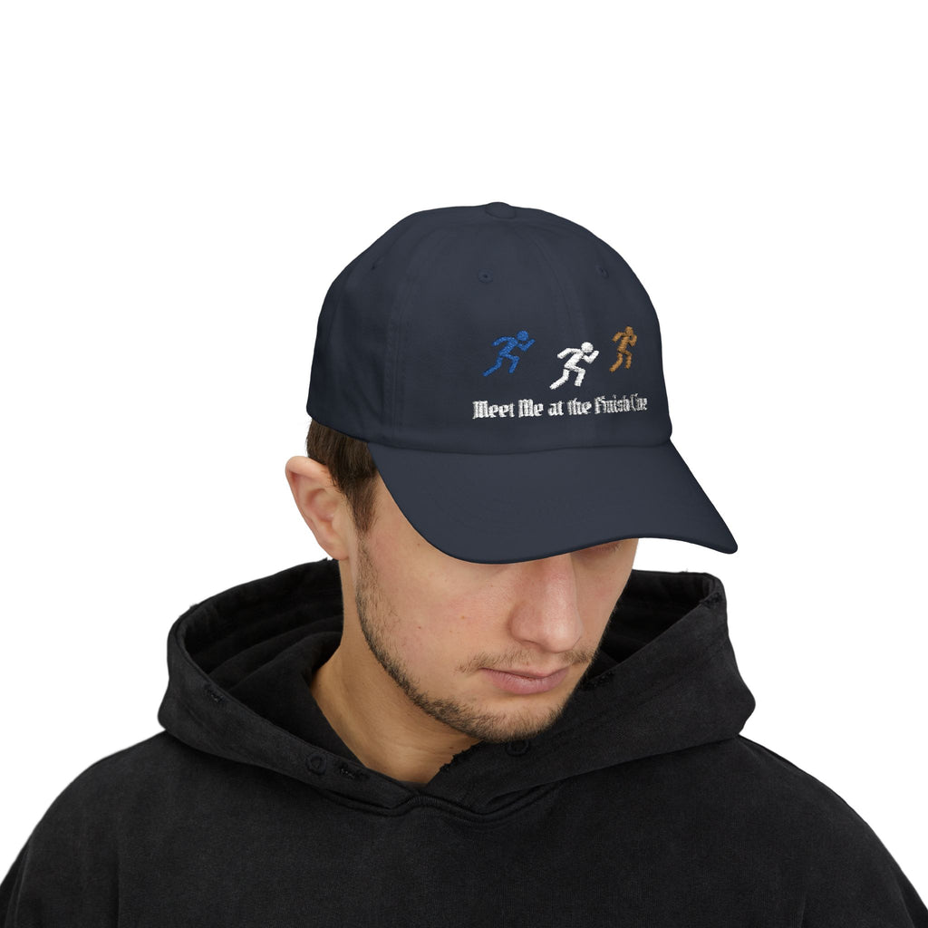 Man wearing a navy embroidered classic dad cap hat with a Meet Me at the Finish Line text and graphic 