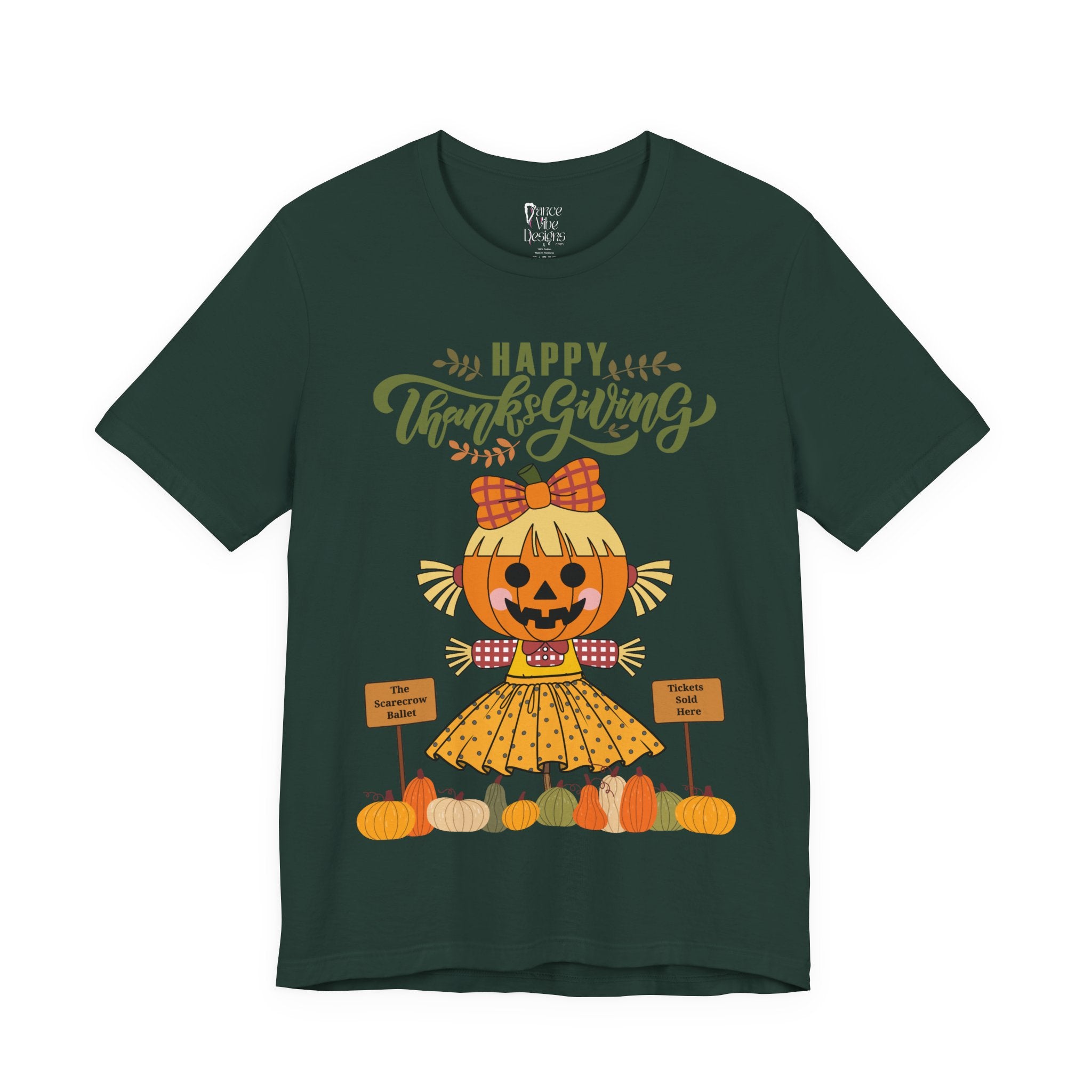 A forest green short-sleeve t-shirt with a Happy Thanksgiving graphic featuring a ballerina scarecrow design.