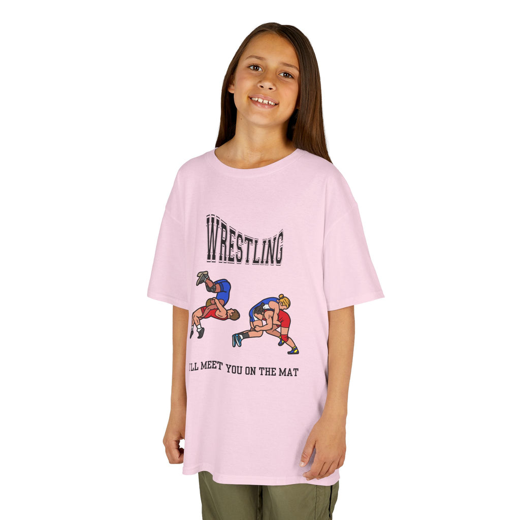 Young girl wearing a youth Gildan 5000B heavy cotton t-shirt in light pink with a Wrestling text and graphic