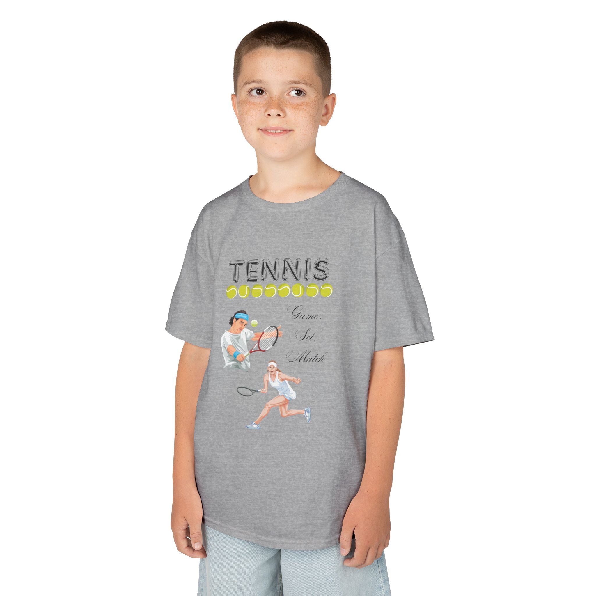 Young boy wearing a youth Gildan 5000B heavy cotton t-shirt in sport grey with a Tennis text and graphic