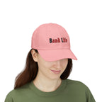 Woman wearing a pink embroidered classic dad cap hat with Band Life text