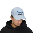 A man wearing a light blue baseball cap with Dance Dad embroidered on the front.