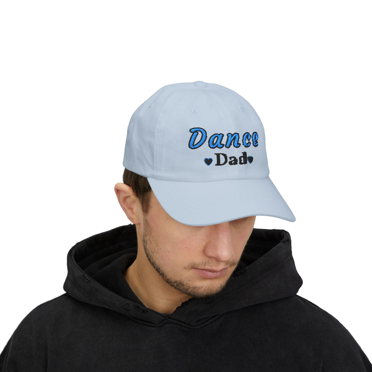 A man wearing a light blue baseball cap with Dance Dad embroidered on the front.