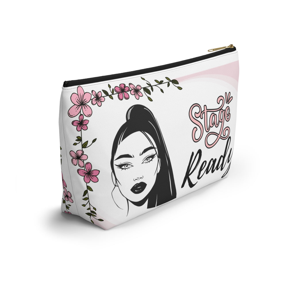 Makeup bag with a stylized face design and floral elements on a white background with black zipper side view