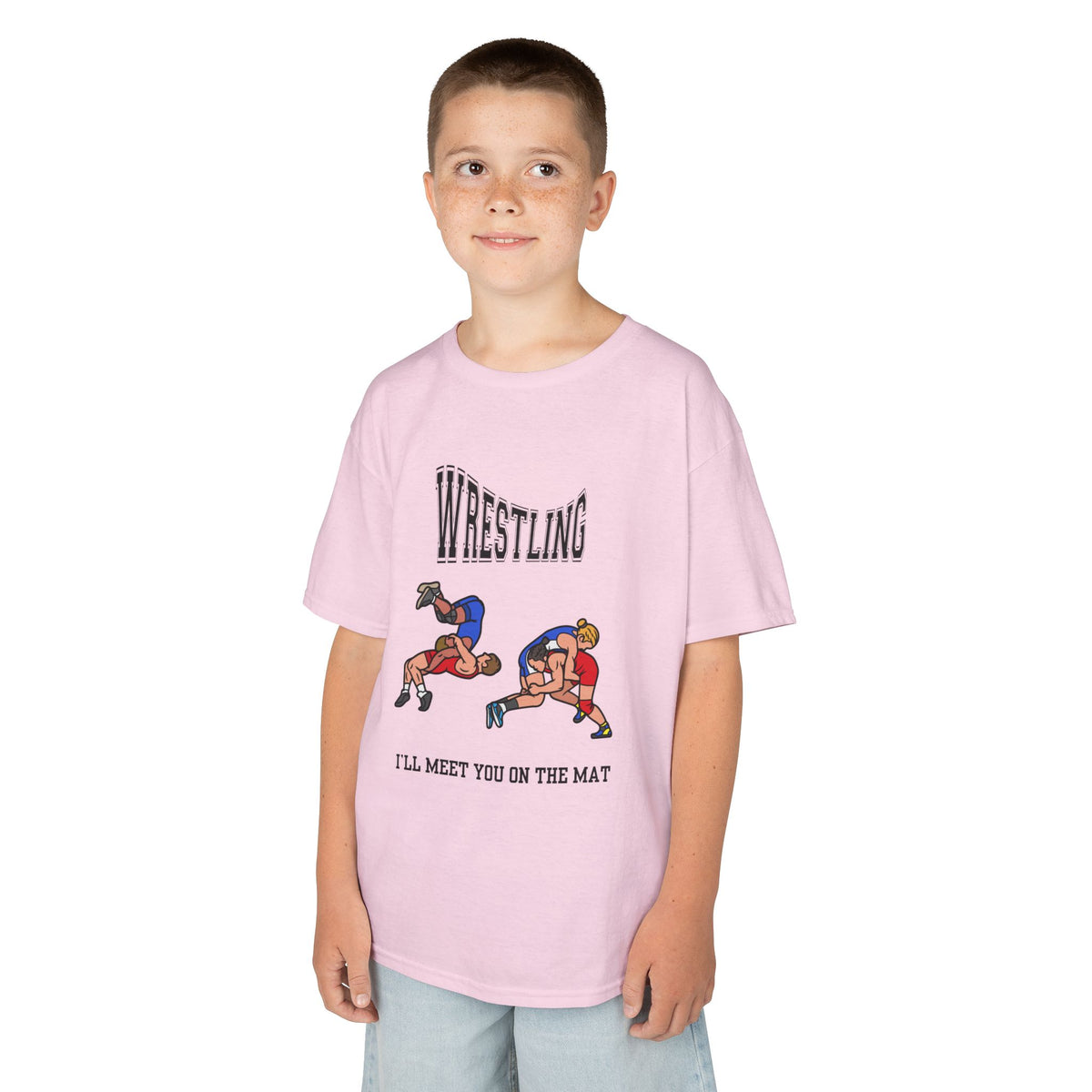 Young boy wearing a youth Gildan 5000B heavy cotton t-shirt in light pink with a Wrestling text and graphic