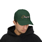Man wearing a spruce classic cap with an embroidered football and text that says Play Ball.