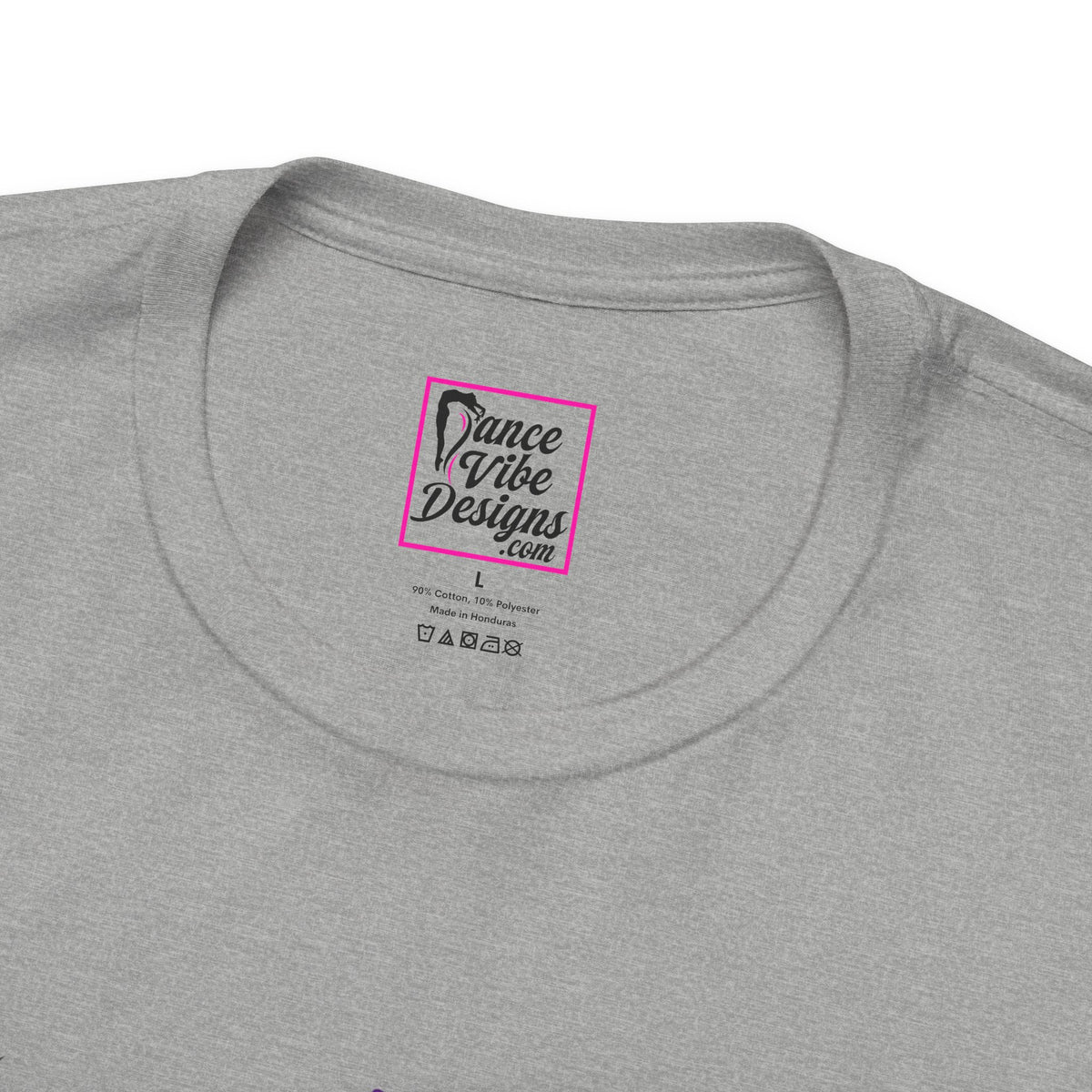 Close up view of a custom Dance Vibe Designs neck label shown over the t-shirt care instructions.