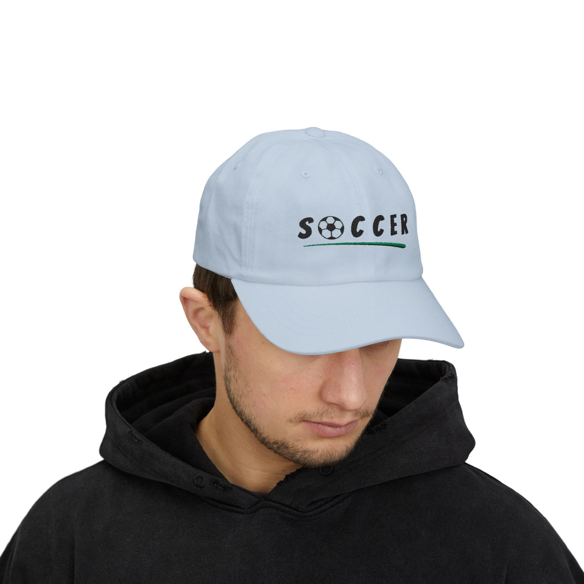 Man wearing a light blue embroidered classic dad cap hat with Soccer text and graphic