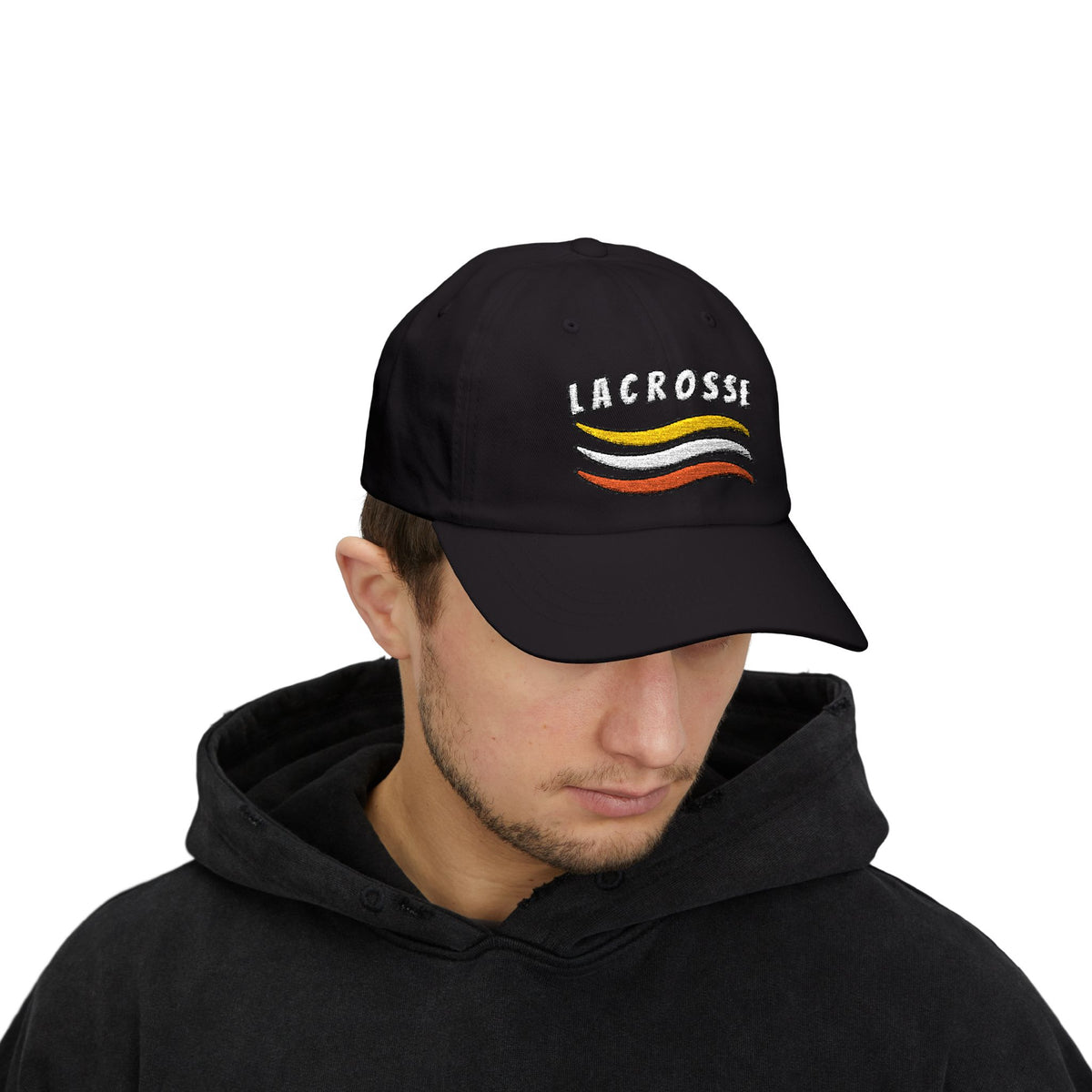 Man wearing a black cap with a Lacrosse text and colorful design embroidered on the front. 