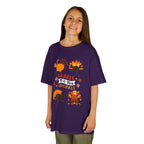 Young girl wearing a purple short-sleeve t-shirt with a colorful graphic of cartoon turkeys and the phrase GOBBLE TIL YOU WOBBLE on the front.